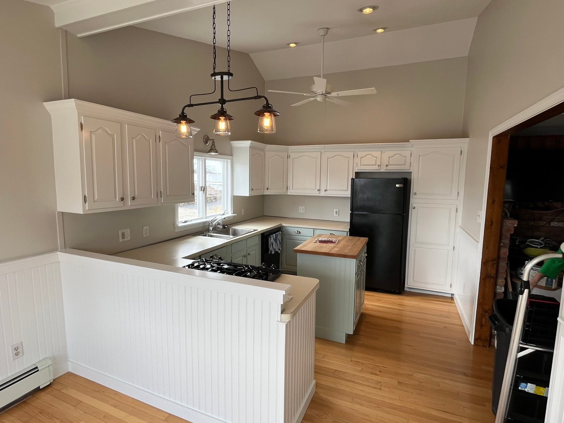 Freshly painted kitchen with white cabinets and trim